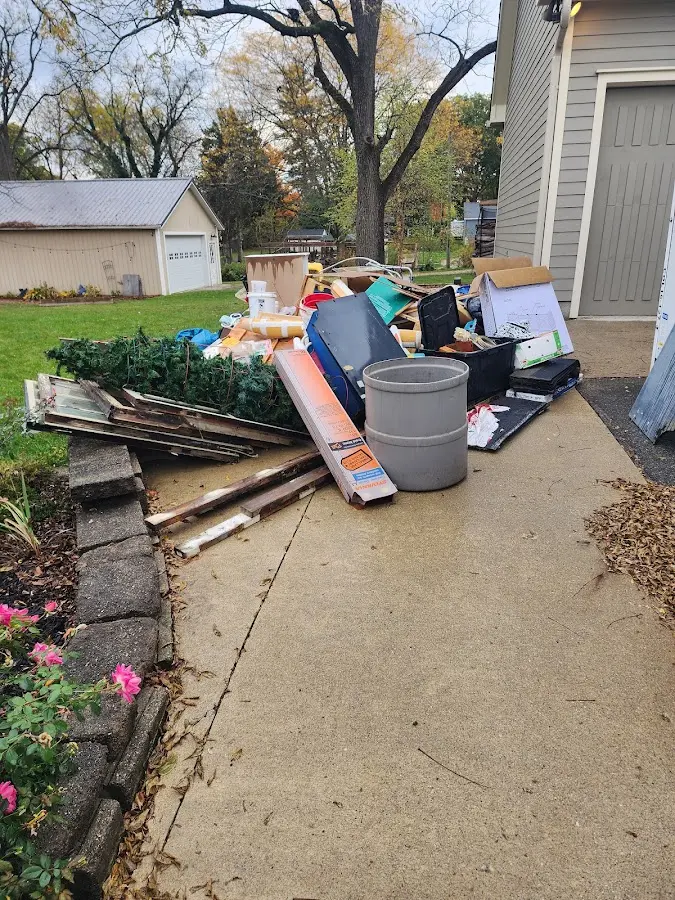 Dumpster being loaded with debris for 10 Yard Dumpster Rental in Beaverton